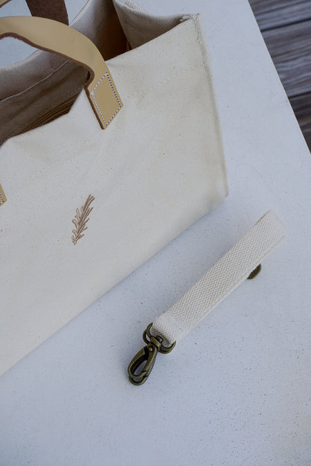 Beige handbag with a strap on a light surface